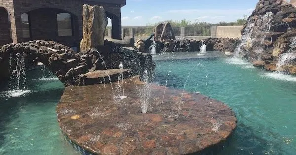 Pool with a rock island fountain and waterfalls
